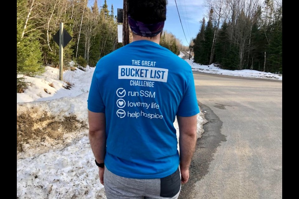 Jonathan Mogg wearing Great Bucket List Challenge Shirt