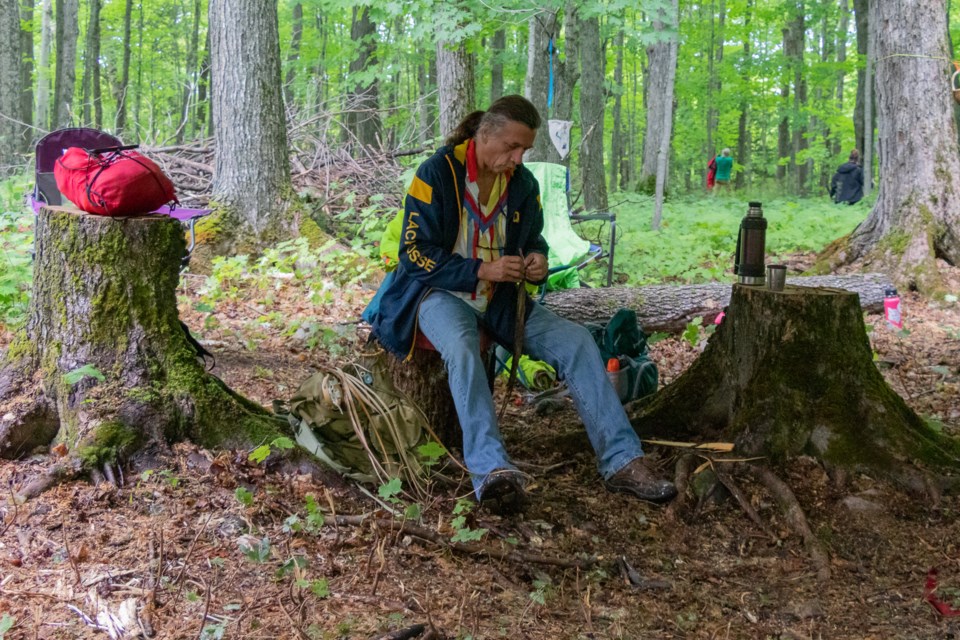 Frank Belleau an Indigenous Knowledge Keeper prepares strips of Cedar bark often used for making basket handles as well as other things_ Child and Nature Alliance Canada Forest and Nature School Practitioners Course