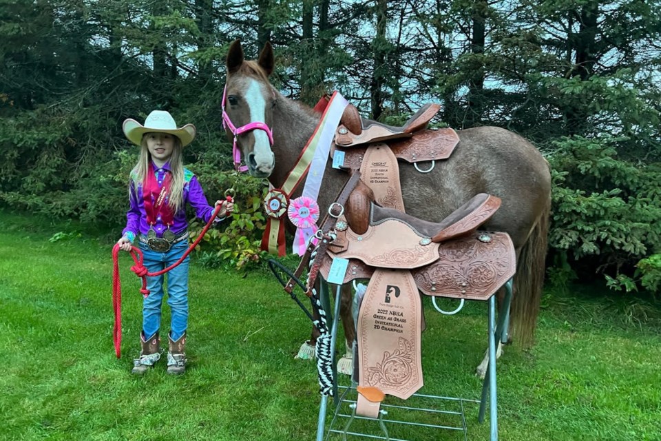 Sophia Borden and Cinnamon sporting their barrel racing winnings. 