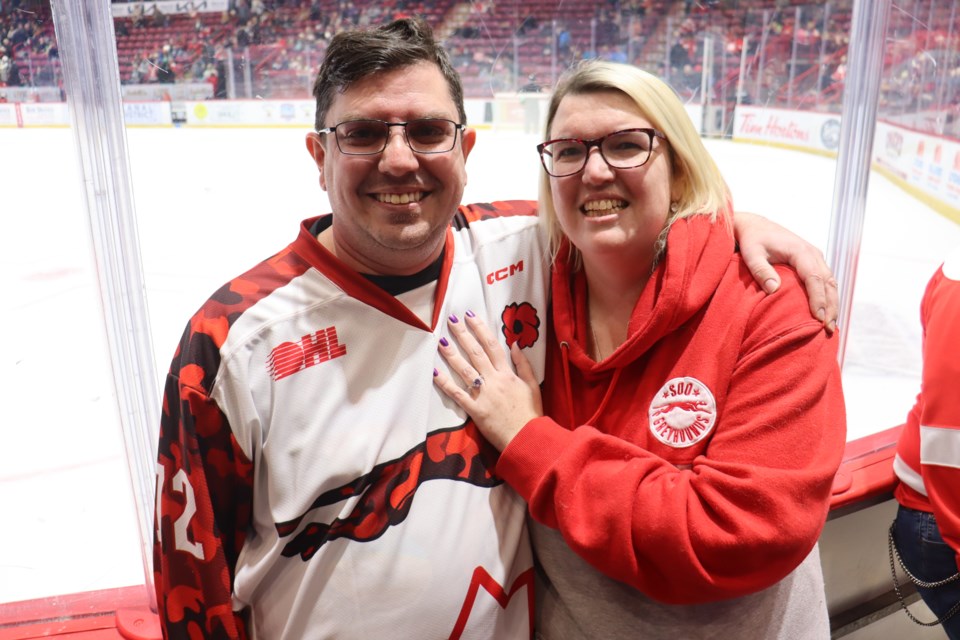 Darren Schrik (left) surprised his now fiancée Michelle Coates (right) by proposing to her during the second intermission of the Soo Greyhounds and Windsor Spitfires game on Jan. 29, 2023. 