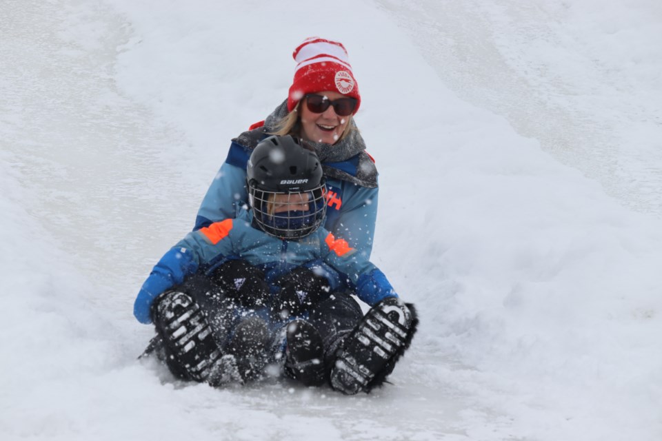 Families enjoyed Bon Soo's popular bum slides on Feb. 4, 2023, which have made an icy and thrilling return to the Canal District next to the Machine Shop.