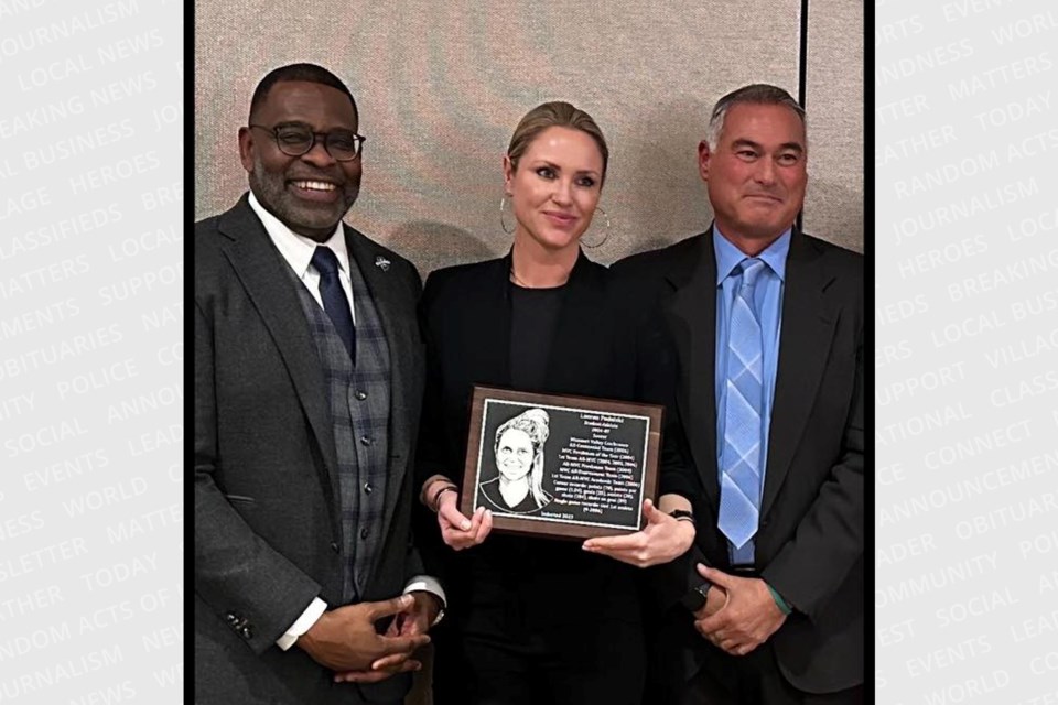 Sault-born soccer star Lauren Podolski (middle) is presented with her Indiana State University Sports Hall of Fame plaque from athletic director Sherard Clinkscales (left) and coach Vernon Croft (right) on Feb. 3, 2023.