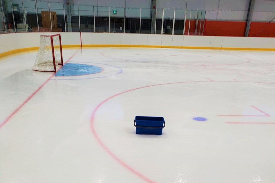 A reader submitted this photo of a bucket collecting water from a rooftop leak above the ice surface inside pad two of the new twin ice pad arena.