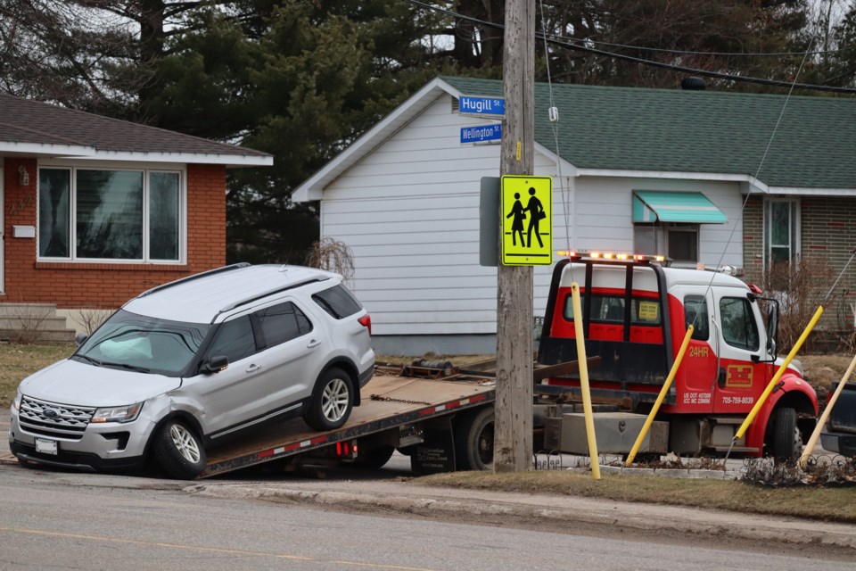 A damaged vehicle is towed from the scene of a collision at the corner of Wellington Street East and Hugill Street on March 27, 2024.