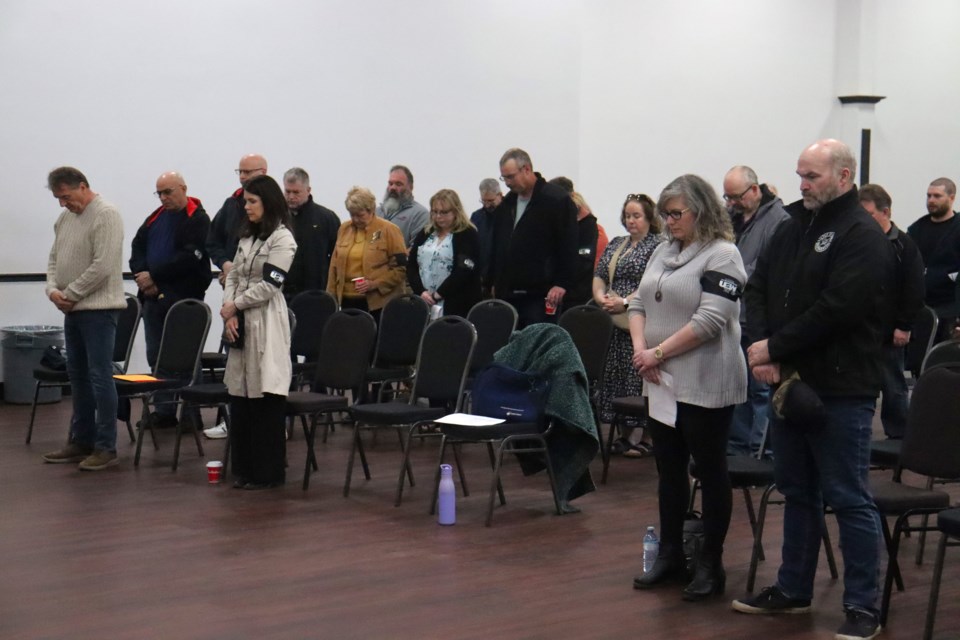 Residents hold a moment of silence for workers who have been injured or killed in the workplace during National Day of Mourning ceremony inside The Queen of Hearts Club in Sault Ste. Marie on April 28, 2024.