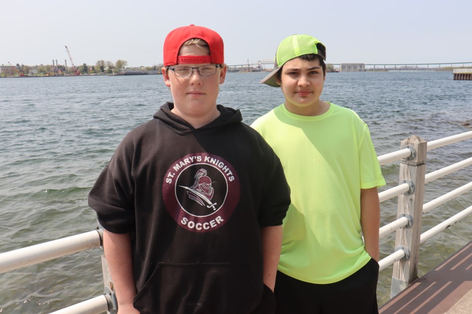 St. Mary's College students Scottie Racicot (left) and Kaige Millette (right) are pictured standing along the boardwalk where they assisted a senior back to her apartment after she was assaulted in her wheelchair on May 12, 2023.
