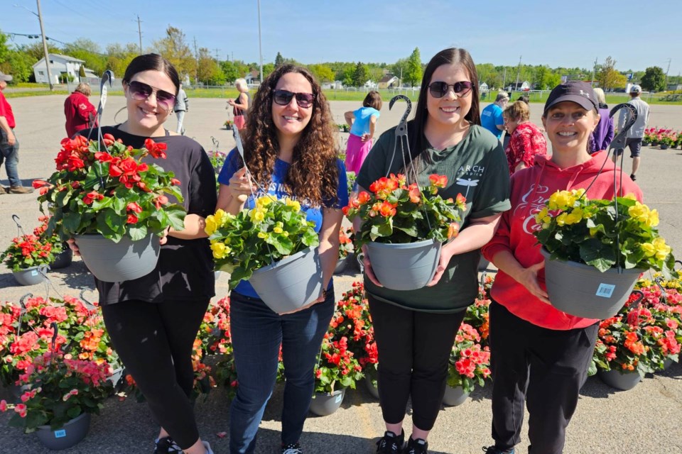 (from left to right) ARCH staff members and volunteers Jenna Polutanovich, Julie Premo, Katherine Williamson, and Lise St. Hilaire helped raise over $10,000 for the hospice with their annual Flower Sale fundraiser.