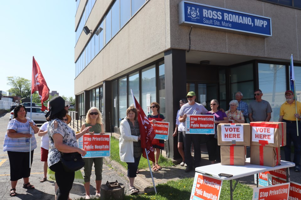 Residents opposed to for-profit, private healthcare gathered in front of Sault MPP Ross Romano's office to hear the results of a non-binding referendum that witnessed nearly 99 per cent of 5,886 Algoma district voters oppose the privatization of public hospitals. 