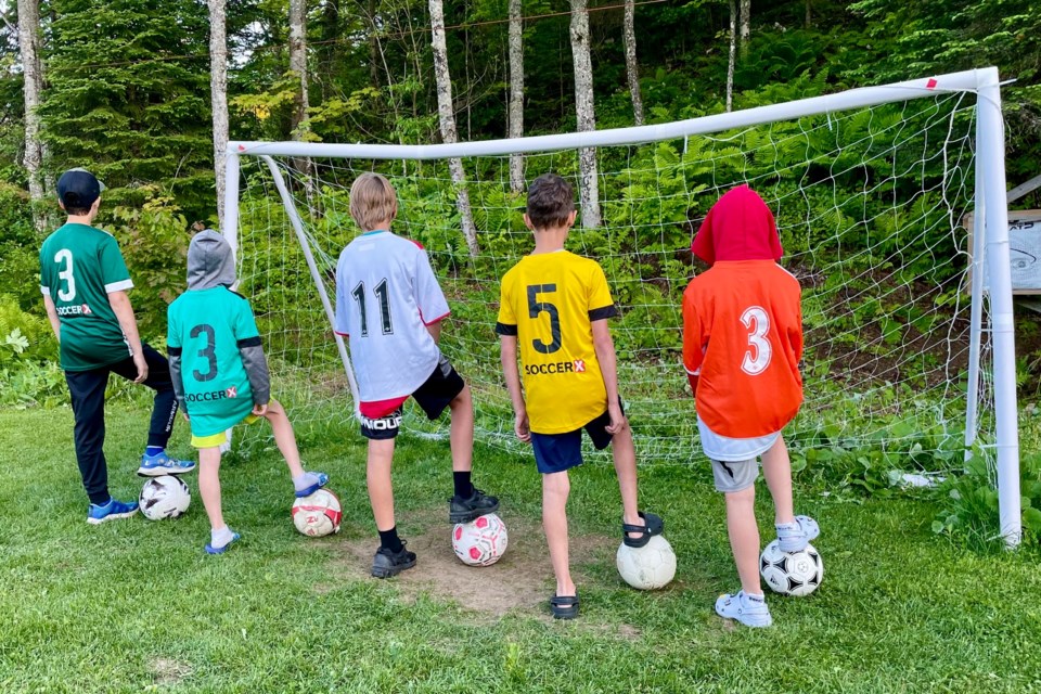 A group of local kids show off some of their soccer attire ahead of a jersey drive at Strathclair Sports Complex in support of Slum2School Africa this month.