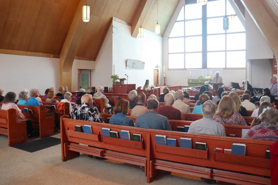 The pews were full inside Holy Trinity Church as members took in their final service inside the 63-year-old structure; the building will be demolished to make way for a 108-unit affordable housing complex.