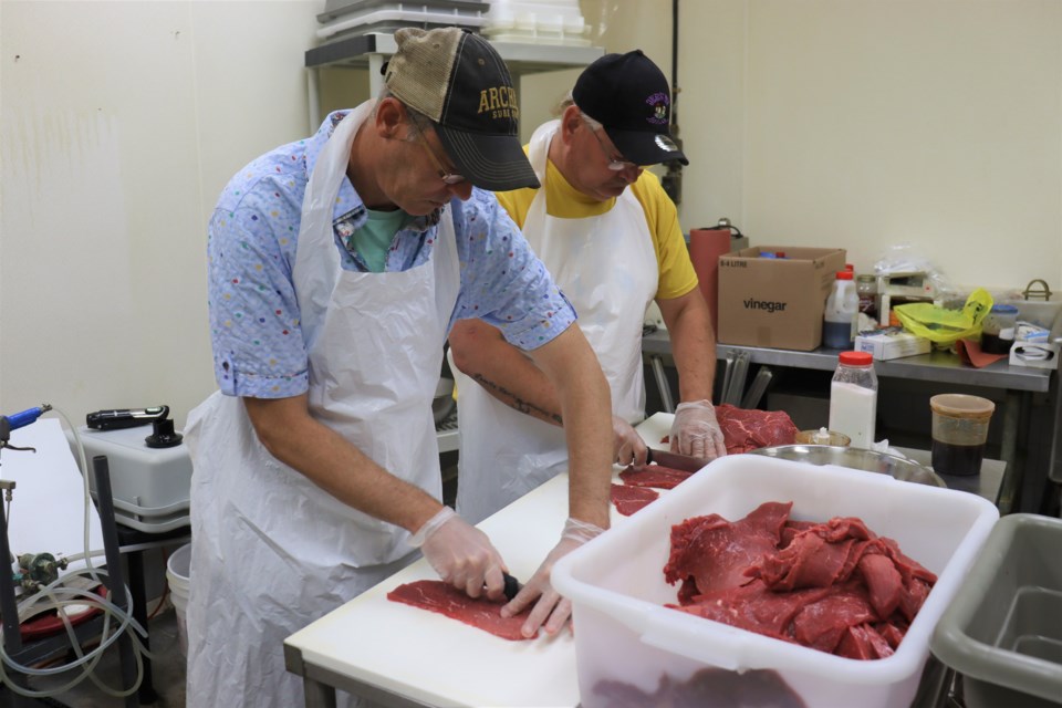 CJ’s Dehydrated Products & Snacks founders Corey Tucker and Joe Rancourt prepare their savoury beef jerky at Bruni's Fine Foods.