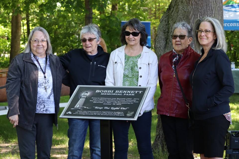 Family members of Bobbi Williamson (nee Bennett) gather around the newly unveiled plaque in honour of the renamed Bobbi Bennett Memorial Park in Gros Cap. 