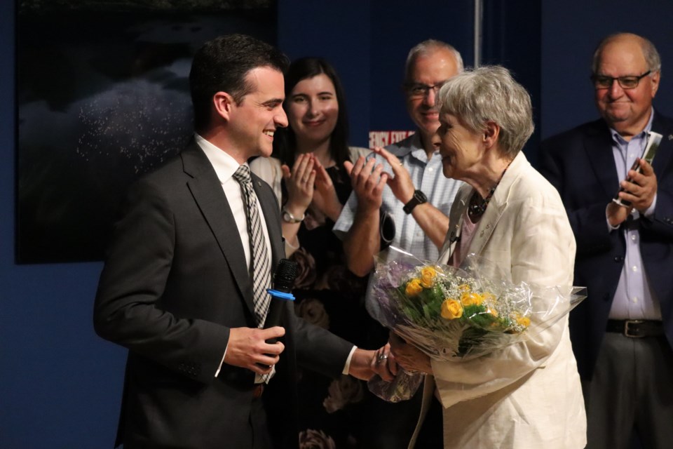 The Sault's Dr. Roberta Bondar is handed a bouquet of flowers from mayor Matthew Shoemaker at the former astronaut's bird migratory photo exhibition at the Art Gallery of Algoma on Jul. 12, 2023
