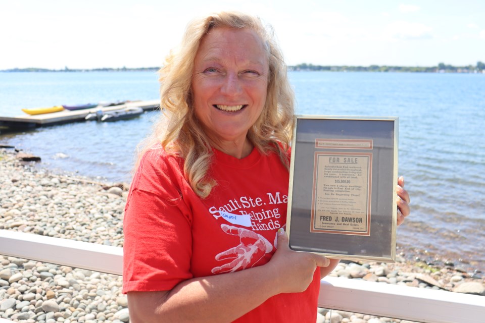 Proudly displaying a slice of local history she received by donation last year, Wendy Gutcher recently made the difficult decision to step away from Helping Hands, citing health issues