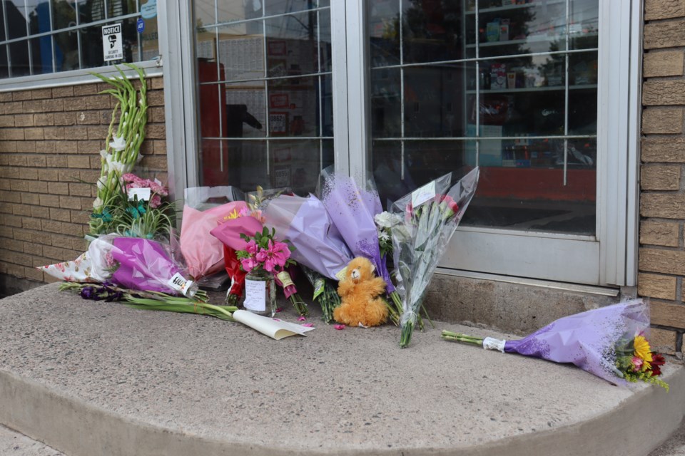 Bouquets of flowers continue to line the steps of Millie's Mini-Mart in the Bayview neighbourhood.