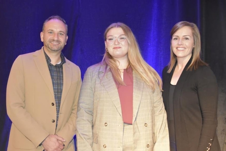 Algoma University first-year student Abigail Hamilton (middle) was presented with the John R. Rhodes Scholarship at a dinner and ceremony on Thursday for her volunteerism and community activism. 