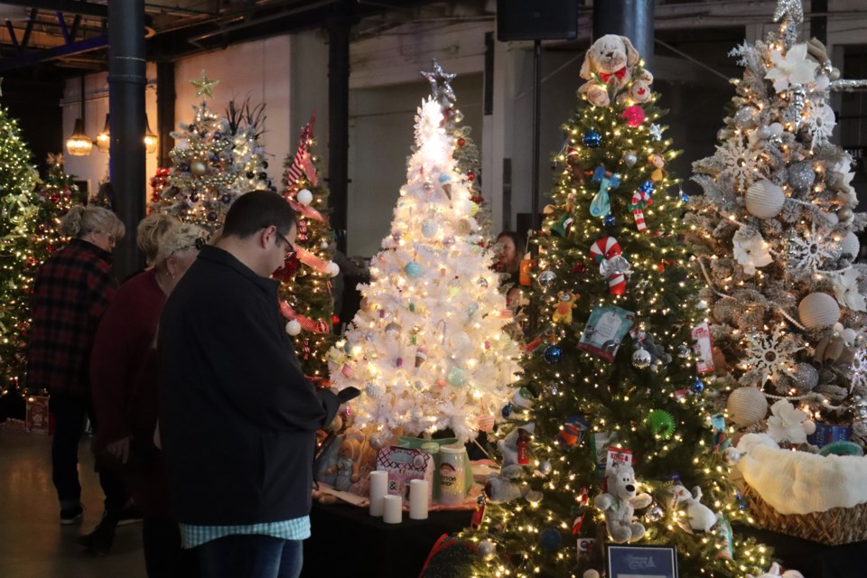 The Machine Shop is dazzling this weekend as residents are bidding on dozens of holiday trees at the 2023 edition of Illuminate the Season with ARCH. 