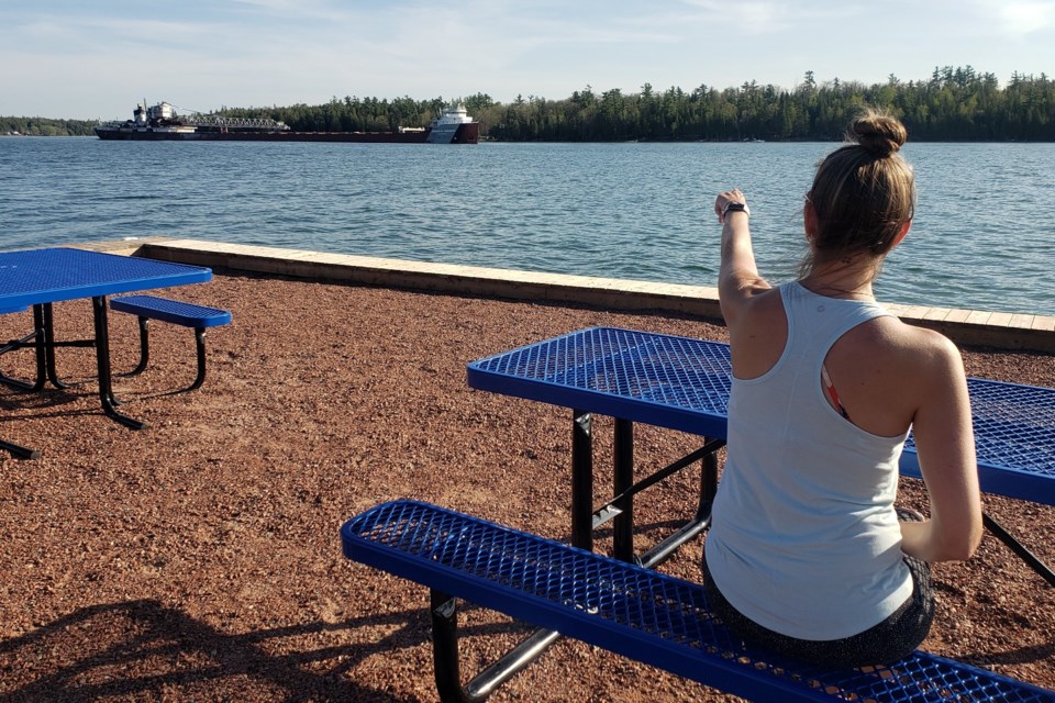 Watching a boat from a new picnic table on the refurbished wharf.