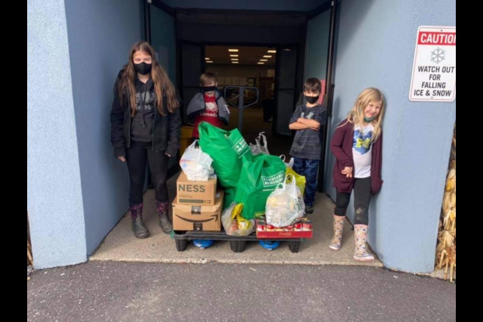 Four siblings help collect food items for Christmas Cheer. Photo submitted by proud Grammy Tammy Berto