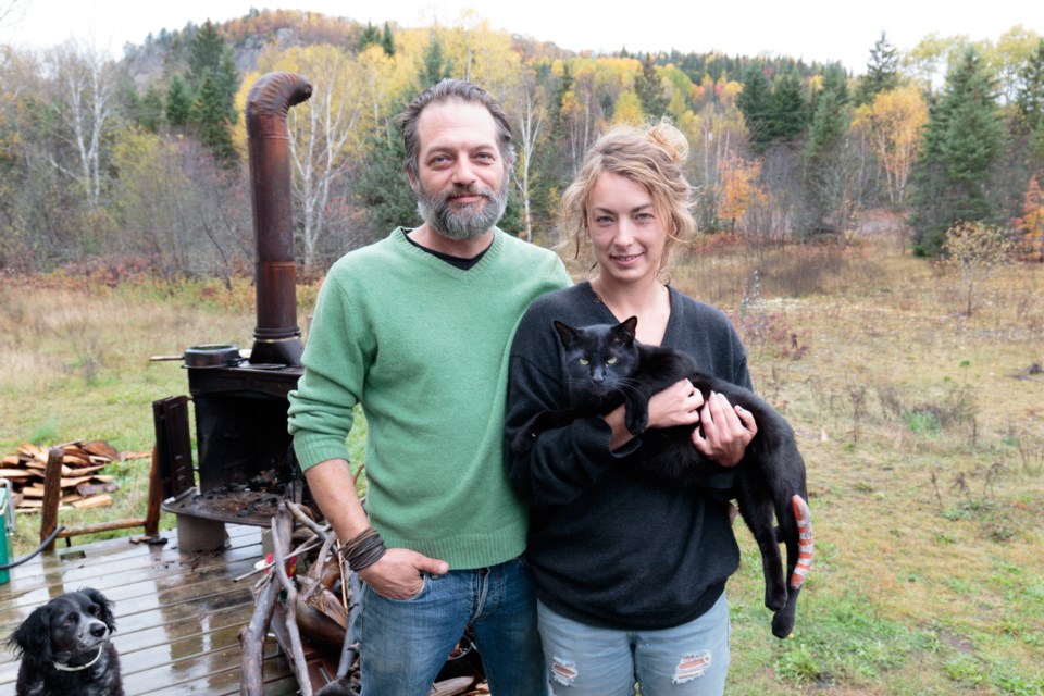 Erik Nowak, Andrea Pinheiro, and Benny. After Benny was shot in the rural areas of Searchmont (background) in September, Pinheiro wants people to know there are dangers for household pets out there. Jeff Klassen/SooToday