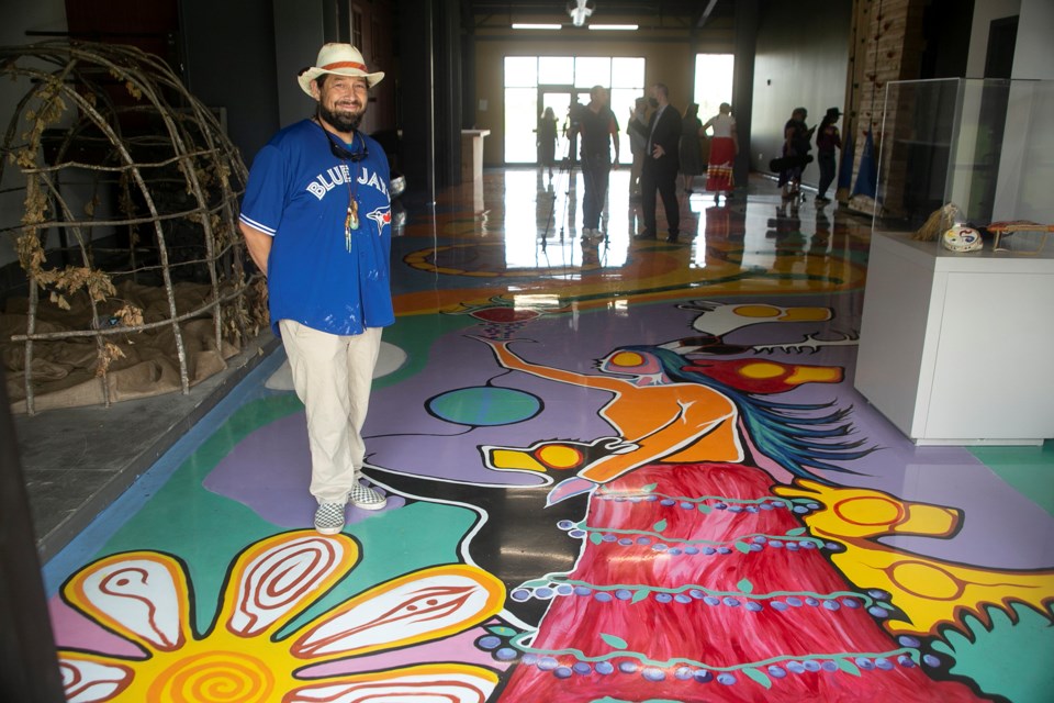 Artist Thomas Sinclair stands on a sprawling floor mural painted in the newly-constructed Agawa Canyon Tour Train station in the Canal District. Kenneth Armstrong/SooToday