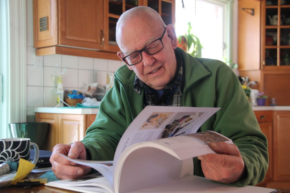 Sault artist Gordon MacKenzie in his home, looking over his latest art instruction book, entitled The Watercolorist’s Essential Notebook - Keep Painting!, Jan. 12, 2018. Darren Taylor/SooToday