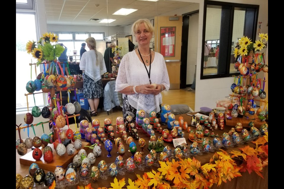 Artist Lidia Silvestrova with her wooden egg art and Matryoshka dolls. Photo provided by Lidia Silvestrova.