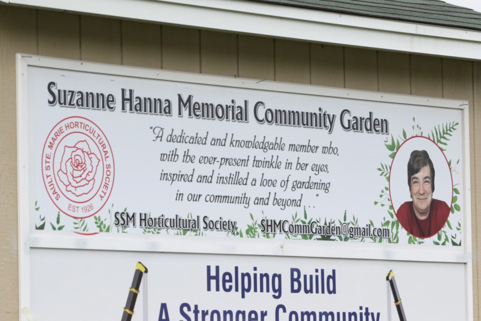 New signage for the Suzanne Hanna Memorial Community Garden was unveiled during a renaming ceremony Monday. 
