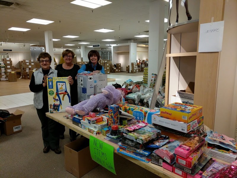 Christmas Cheer headquarters is set up in the old Sears at Station Mall and volunteers are hard at work processing donations. Photo by Corrie Davidson/Bulletin