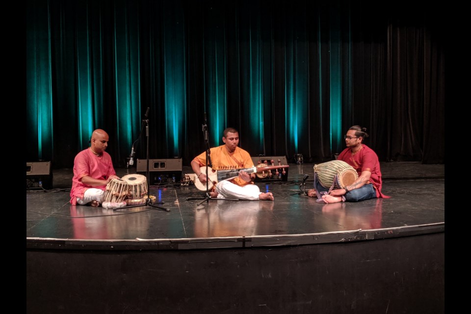 Ananda playing the tabla drum, Dwarkanath playing the sarod and Gopal playing the mrdunga drum