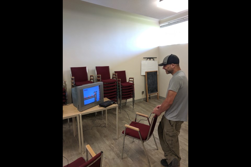 A new comer to Retro Video Night enjoys an old favourite at this month's event being held at the library focusing on retro game icons