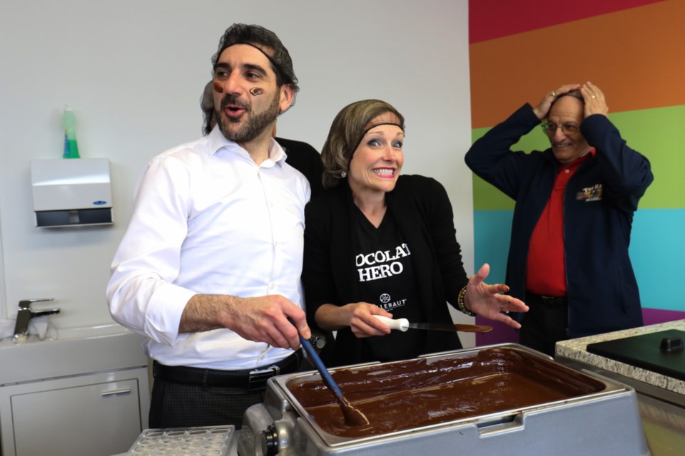 Sault Ste. Marie MPP Ross Romano, left, hams it up with Centre for Social Justice and Good Works Executive Director Christina Coutu while learning to make chocolate during a provincial funding announcement for the Sweet Change Chocolate Company. James Hopkin/SooToday 