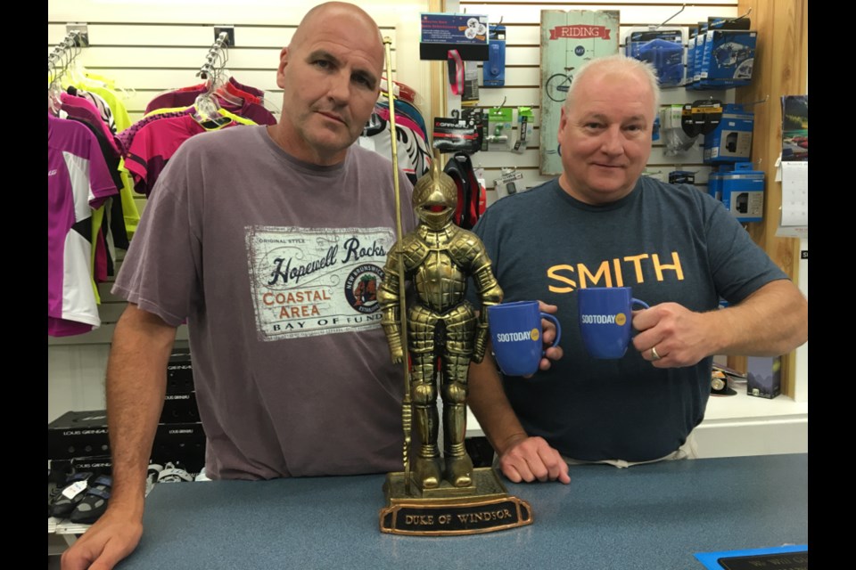 Mark Pettalia, Duke of Windsor Sport Shop sales and service technician, and Chris Theriault, Duke of Windsor Sport Shop owner/operator, with a pair of SooToday mugs.  Darren Taylor/SooToday