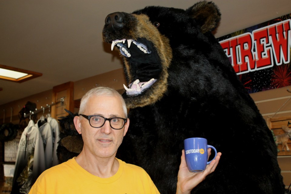 Orest Witiw, Trading Post co-manager, with a SooToday coffee mug and giant, furry friend, Sept. 6, 2017. Darren Taylor/SooToday
