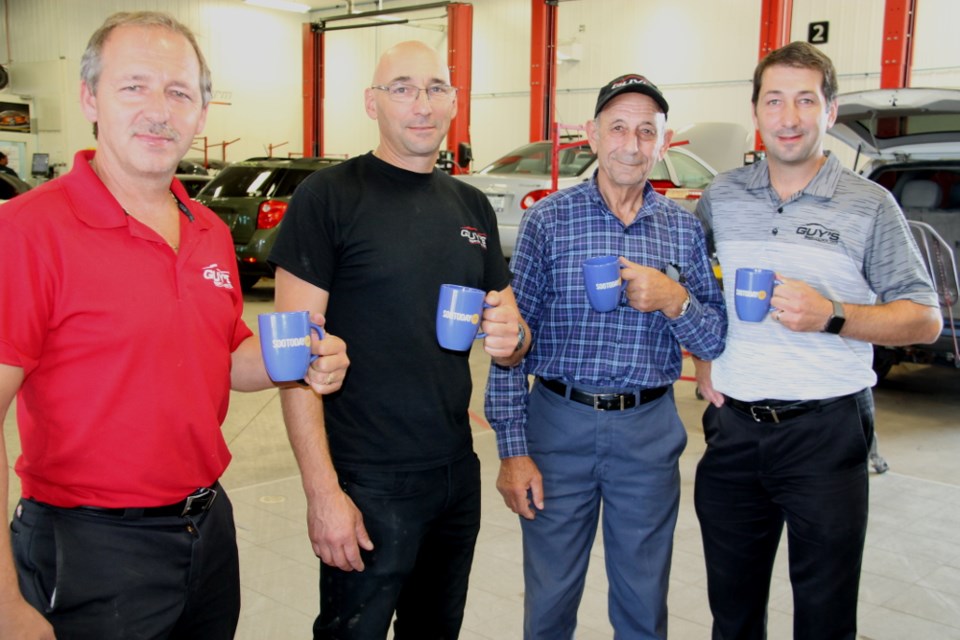 Rob, Dennis, Guy and Nello Iannelli hold their SooToday mugs at Guy’s B&R Collision Centre at 1044 Great Northern Road, Sept. 27, 2017. Darren Taylor/SooToday