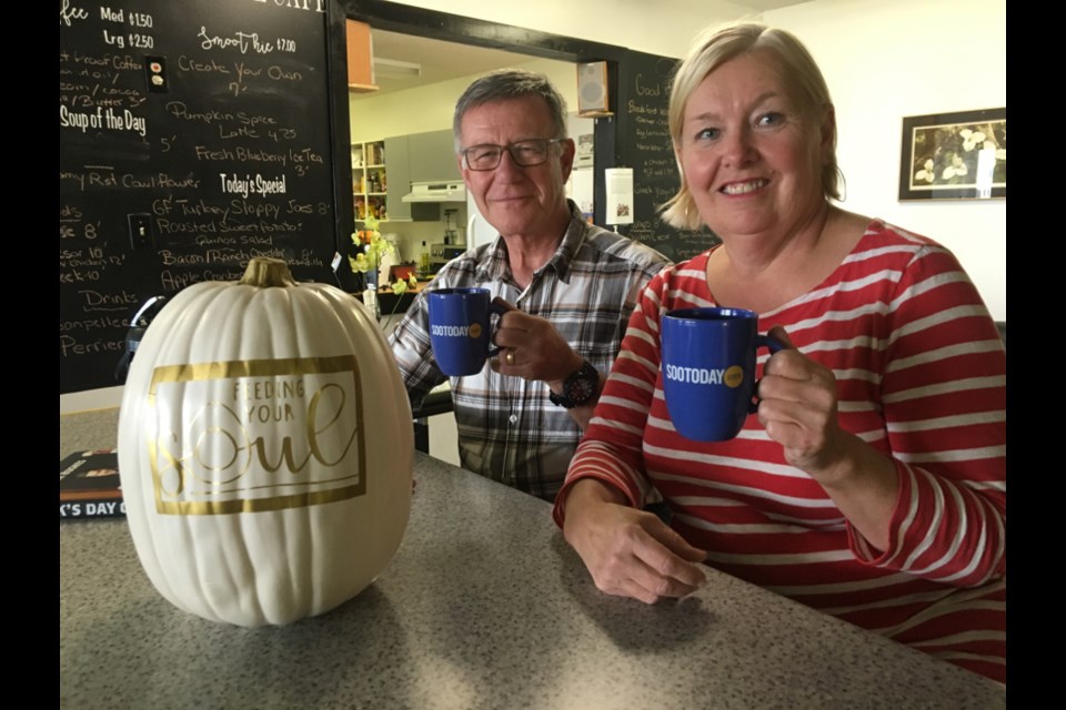 Mary Greenwood, owner/operator of new Sault eatery Feeding Your Soul, with husband Deane Greenwood, sporting their SooToday mugs, Oct. 25, 2017. Darren Taylor/SooToday