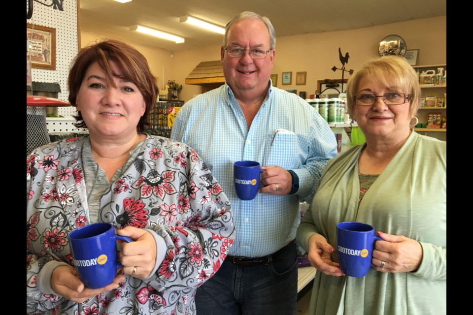 Jim Shaw, Shaw Milling owner/operator, with staff members Jennifer Berry and Diane Cristillo with SooToday mugs, Nov. 22, 2017. Darren Taylor/SooToday