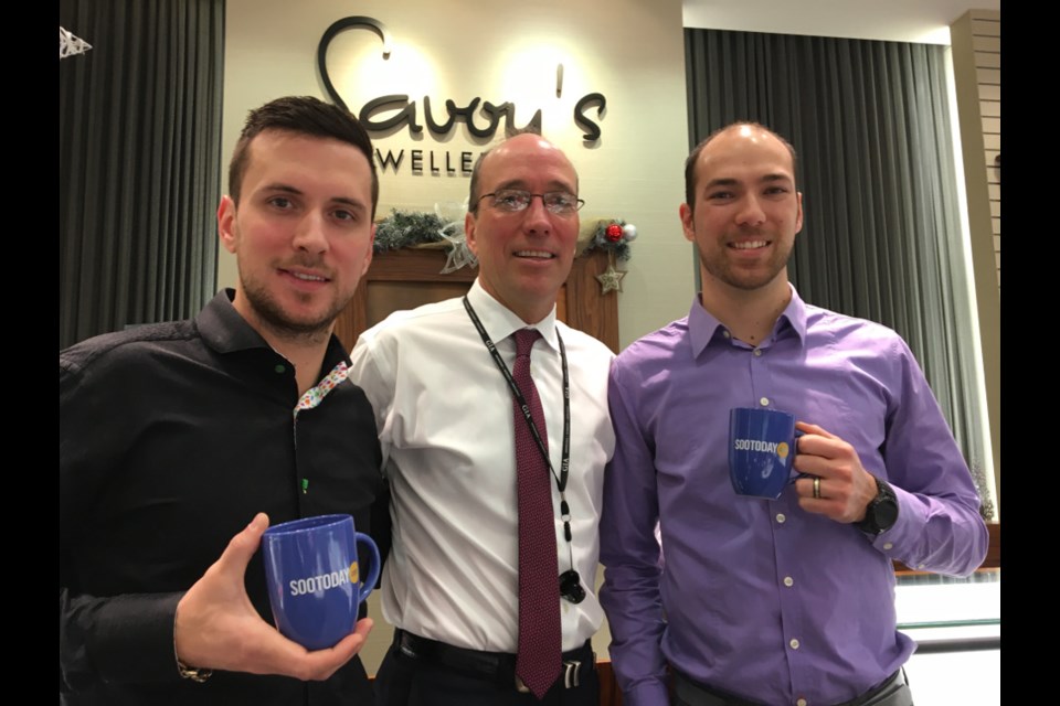 Ryan, Rodger and Nicholas Rosset of Savoy’s Jewellers with their complimentary SooToday mugs, Dec. 13, 2017. Darren Taylor/SooToday
