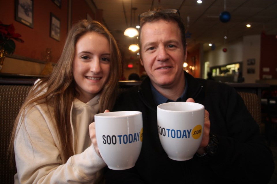 Muio’s owner Rob DiRenzo and daughter/employee Amanda with their complimentary SooToday coffee mugs, Jan. 3, 2018. Darren Taylor/SooToday
