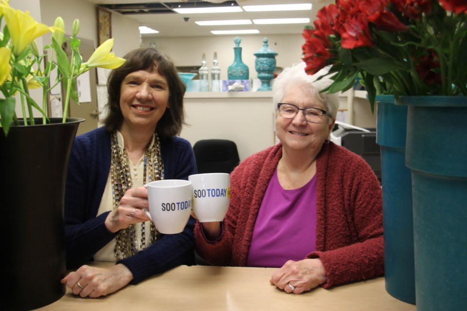 Gudrun Schatzler and Shirley Richards, co-owners and operators of Mann Florist, with their complimentary SooToday mugs, Jan. 10, 2018. Darren Taylor/SooToday

