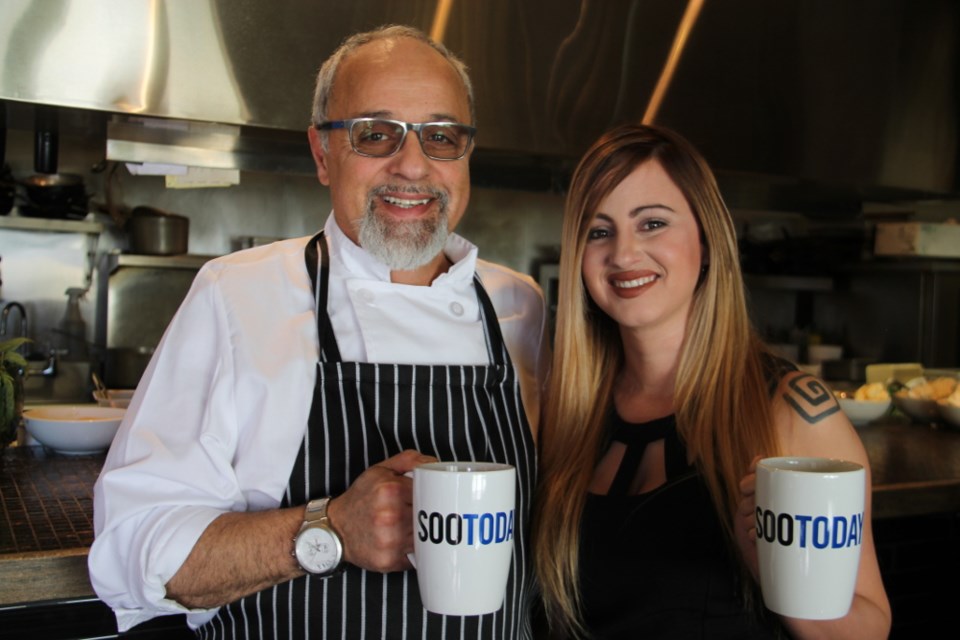 Antico Ristorante chef/owner Arturo Comegna and server Yaneysis Garcia Pacheco with their complimentary SooToday mugs, March 21, 2018. Darren Taylor/ SooToday