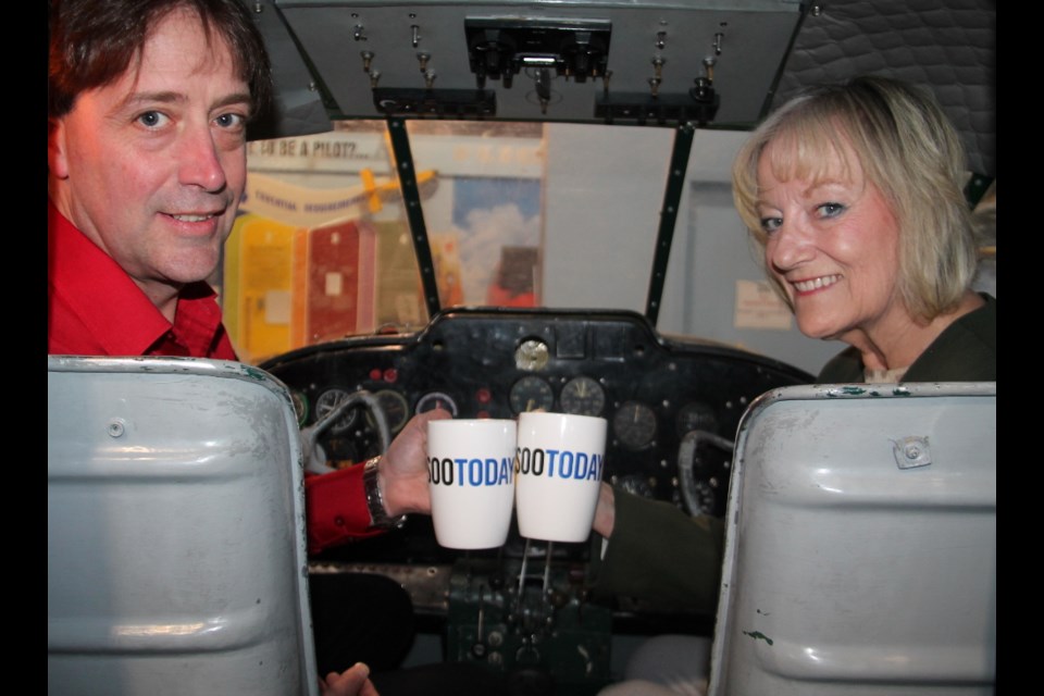 Dan Ingram, Canadian Bushplane Heritage Centre executive director, and Edie Suriano, the Centre’s marketing and promotions coordinator, with their complimentary SooToday coffee mugs, May 9, 2018. Darren Taylor/SooToday