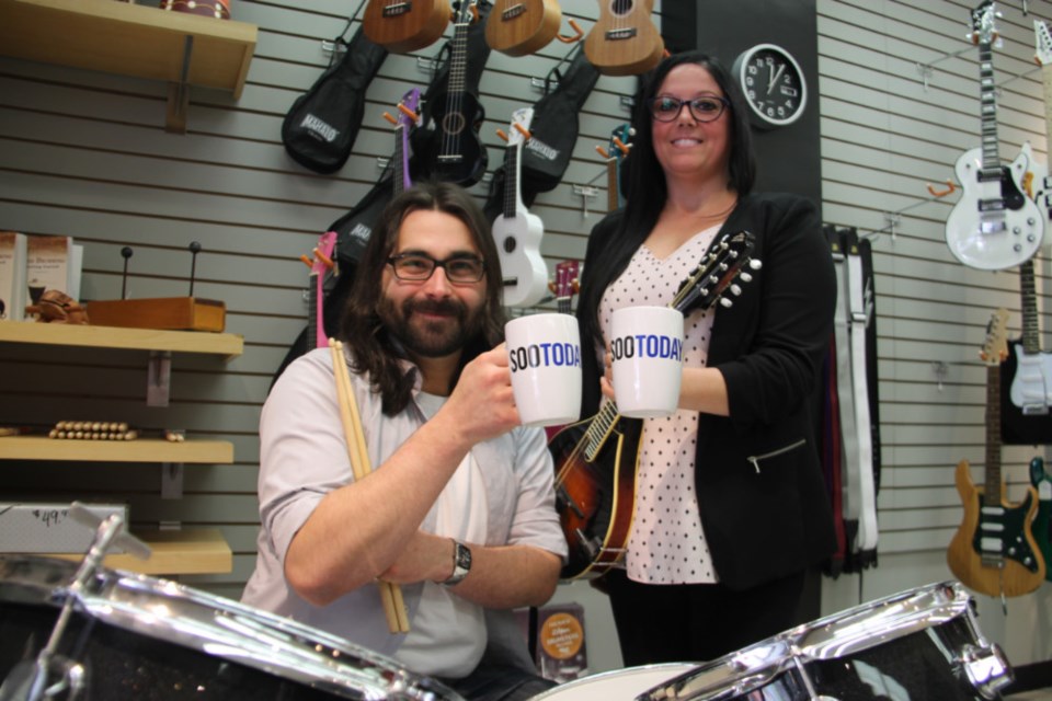 Jake Rendell and Carrie Suriano, co-owners of Case's Music, with their complimentary SooToday mugs, June 13, 2018. Darren Taylor/SooToday