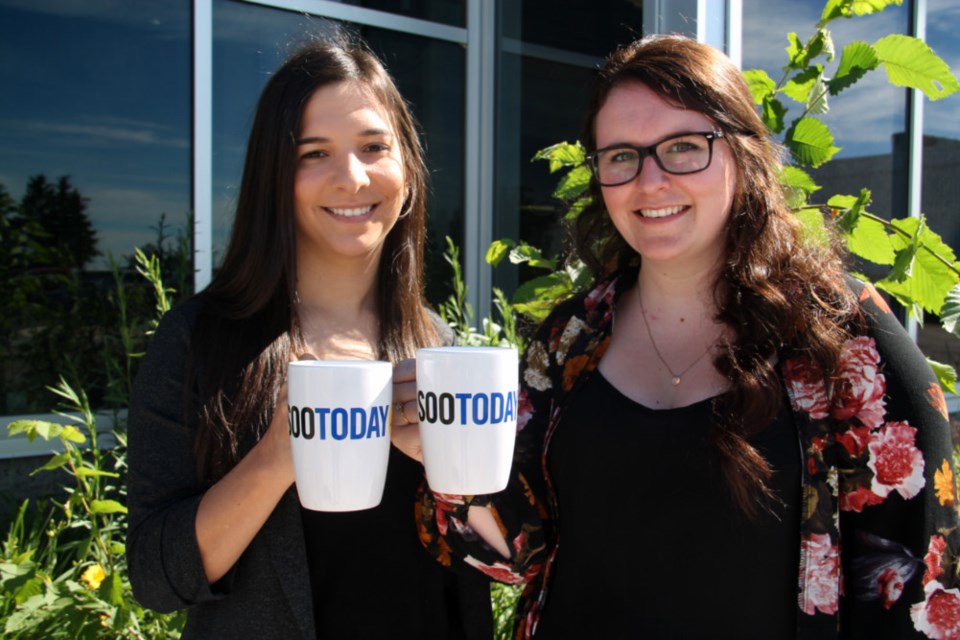 The Invasive Species Centre's Rebecca Schroeder, aquatic invasive species liasion, and Lauren Bell, education and community outreach coordinator, with their complimentary SooToday coffee mugs. Darren Taylor/SooToday