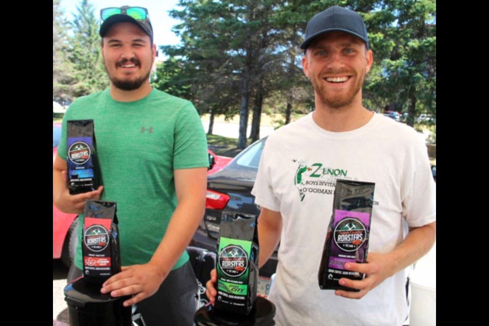 Lars Moffat (right), owner of Copper Country Coffee Roasters, with his employee, Keaton Schmidt, at the Algoma Farmers’ Market. Photo supplied by the SSMEDC.