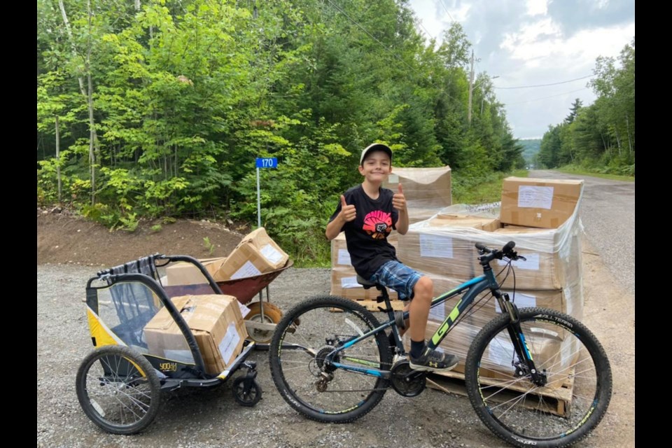 Wyatt Mageran with boxes of ‘message bottles’ ready for purchase and to be sent to people worldwide who need a lift during the pandemic, purchased by his stepmother Sarah Lewis for 4the Love