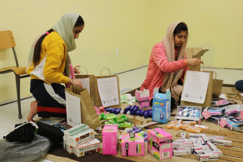 Two sevadaars, or volunteers, assemble care packages for Pauline's Place and Women in Crisis Algoma for International Women's Day and the global One Billion Rising campaign. James Hopkin/SooToday