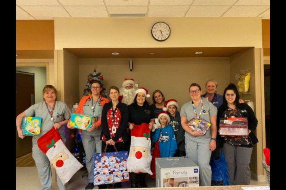 Amanda Johnston and Heather Hilderley-Phillips, right of Santa Claus, with Sault Area Hospital (SAH) paediatric wing and Neonatal Intensive Care Unit (NICU) staff, delivered gifts to young patients hospitalized during Christmas, Dec. 23, 2019. Photo supplied

