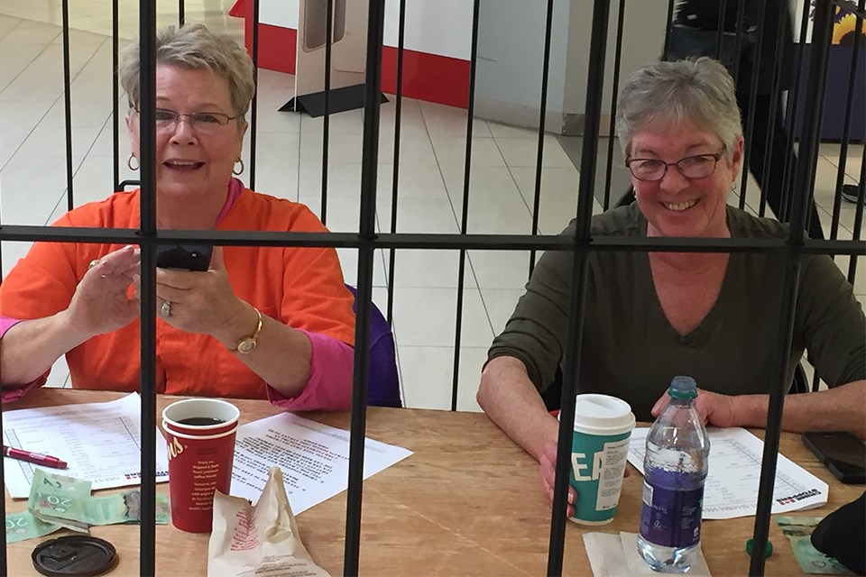 Audrey Greenwood, left, and Carol Willet hard at work raising bail during the Great Algoma Lock-Up. Derek Turner/SooToday