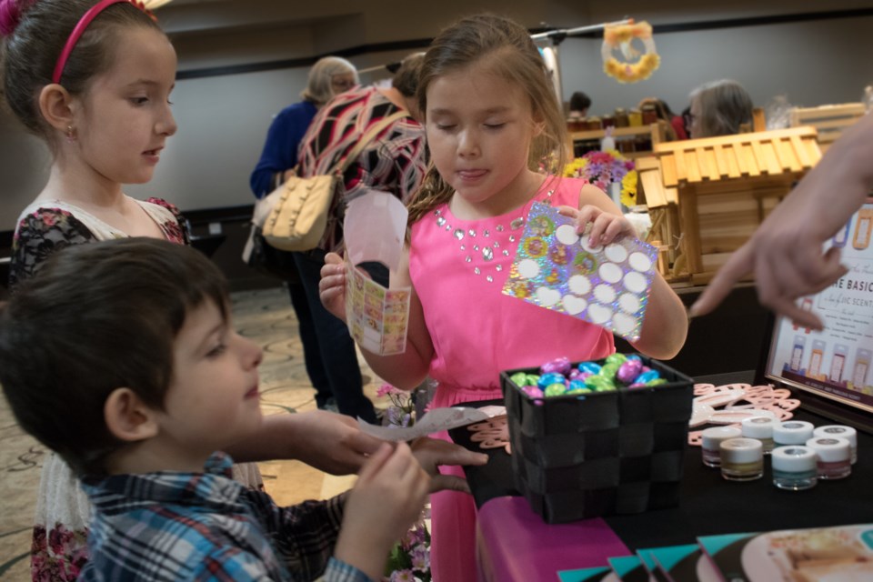 Crime Stoppers hosted an Easter Activities for Kids & Vendor Event at Quattro Hotel and Conference Centre on Saturday. (From left) Madison, 7, and brother Kailem, 3, get Easter Eggs and stickers from Sophia, 7, and her aunt as part of the scavenger hunt activity. Jeff Klassen/SooToday